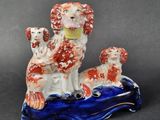 a figurine of two dogs sitting on a boat