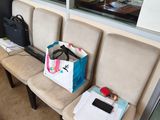 three chairs in the waiting room with bags on them