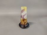 a small glass vase with a yellow and white design on it