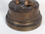 a bronze statue of a man and a dog on a pedestal