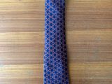 purple and blue patterned tie on a wooden table