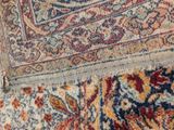 an image of a close up of a rug with a cat on it