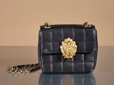 an image of a black purse with a gold lion head on it