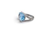 a close up of a ring with a blue topaz stone