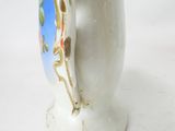 a white vase with a picture of a woman on it