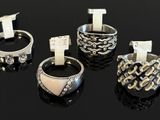 four different types of rings on a black surface