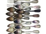 a lot of spoons and forks arranged in a row