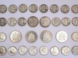 an image of a collection of silver coins on a white surface