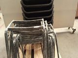 a stack of chairs sitting on a pallet in a room