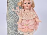 a doll that is sitting in front of a box