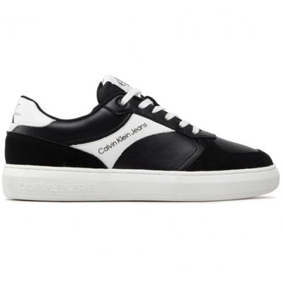 a black and white sneakers with a white sole