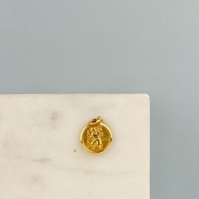 a close up of a gold coin sitting on top of a marble table
