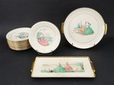 three plates and a tray with a picture of a woman in a garden