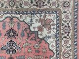 an image of a pink and blue rug with a floral design on it