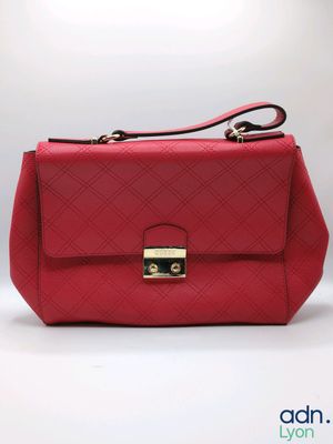 a red handbag with a gold lock on the handle