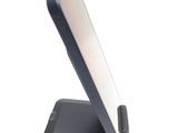 a cell phone sitting on a stand on a white surface