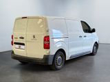 the back of a white van is parked in a large room