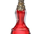 une image représentant un flacon de parfum en verre rouge muni d'un bouchon doré