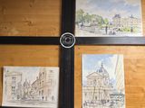 four paintings on the wall of a building with a camera