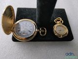 a gold pocket watch and a gold pocket watch on display