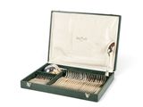 a green case with silverware in it on a white surface