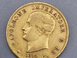 a close up of a gold coin with a man ' s face on it