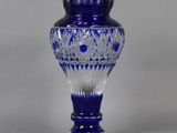 an image of a blue glass vase on a gray background
