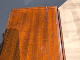 a wooden table with a drawer on top of it