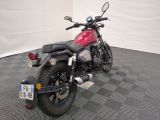 a red motorcycle that is parked on a checkered floor