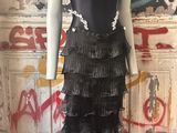 the mannequin is standing in front of a wall with graffiti on it