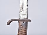 a knife that is sitting on top of a piece of wood