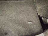 a small hole in the floor of a car