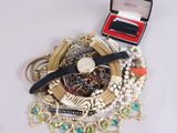 a box with a watch, bracelets, and other jewelry on it
