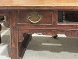 a wooden table with a drawer on top of it