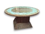 a table with a glass top and a metal base