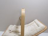 a wooden rocking chair with a white blanket on it
