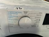 a close up of a button on a washing machine
