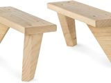 two wooden benches sitting next to each other on a white surface