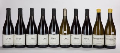 a group of six bottles of wine sitting next to each other