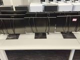 many computers on the desks in the room