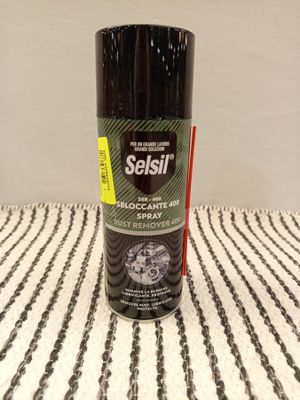 an image of a bottle of sealil on a striped tablecloth