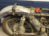 a motorcycle that is sitting on the floor in the garage