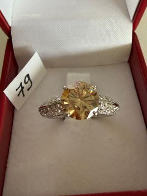 a yellow diamond ring in a red box with a price tag