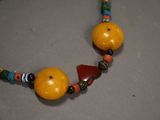 a close up of a necklace made of beads and beads
