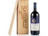the bottle of wine is next to a wooden box with a wine opener