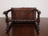 a small wooden chair that is on a wooden table