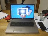 a laptop that is sitting on a desk with a cell phone
