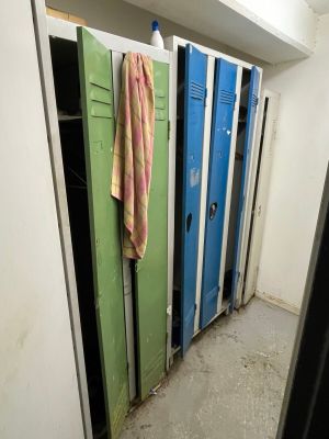 several lockers in the hallway of a building with a towel hanging on the door