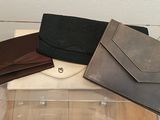 three wallets sitting on top of each other on a table