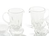 a lot of glasses and a pitcher on the table